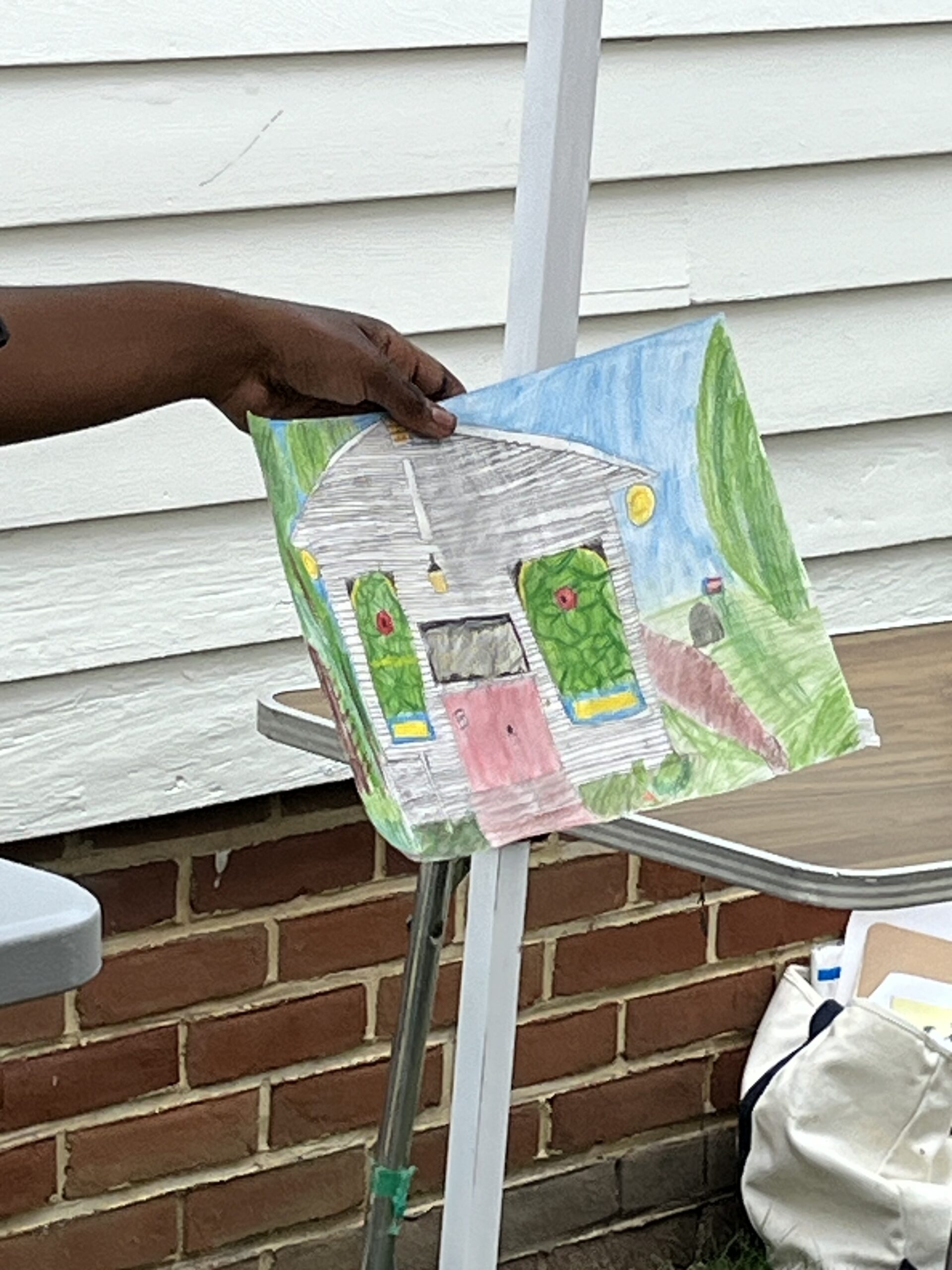 UGRR Camper holds up a drawing of the Chapel